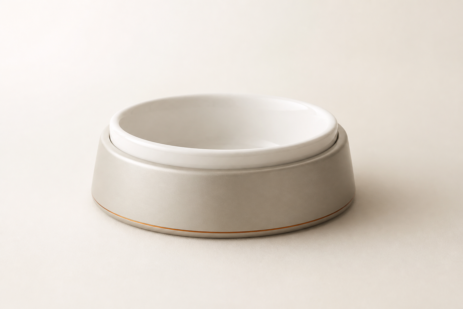 A bone-white ceramic dog bowl set into a matte aluminium base