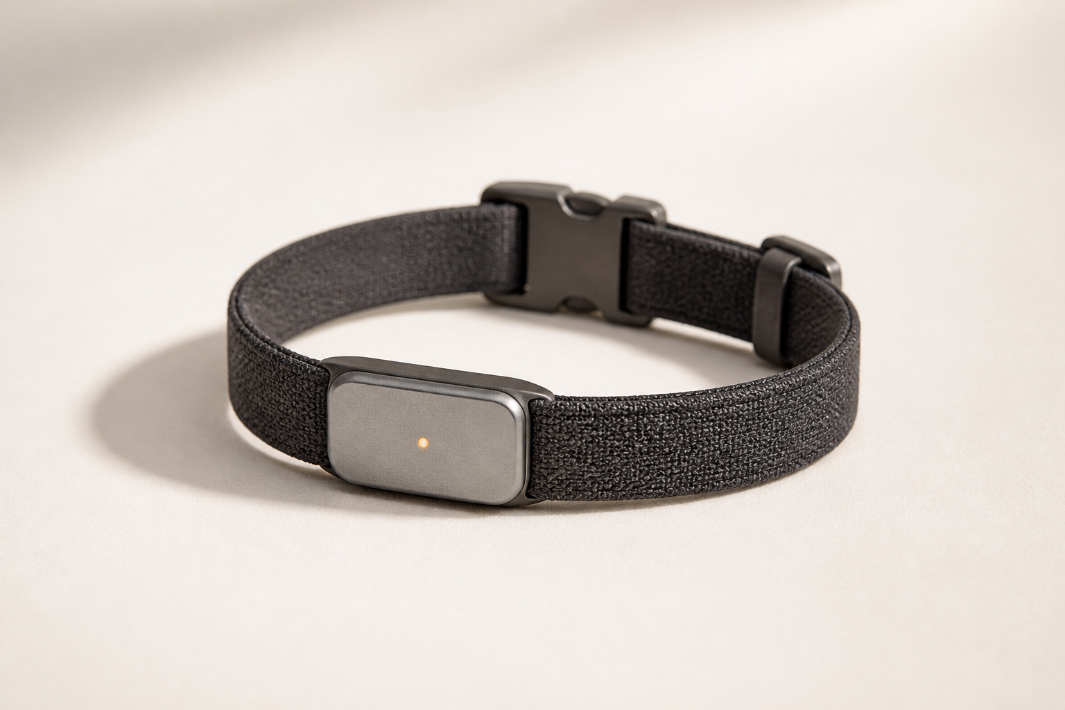 A charcoal woven smart collar with a brushed aluminium module